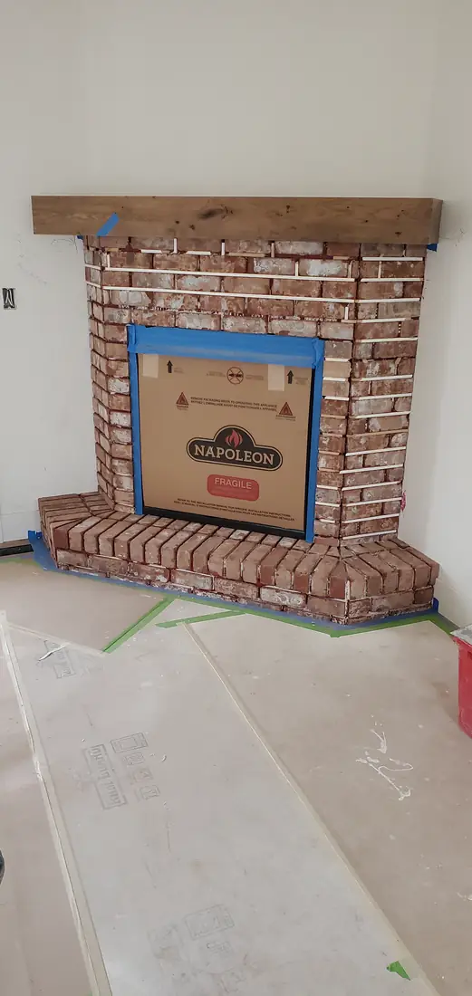 Brick stone veneer fireplace surround under construction in Oregon home