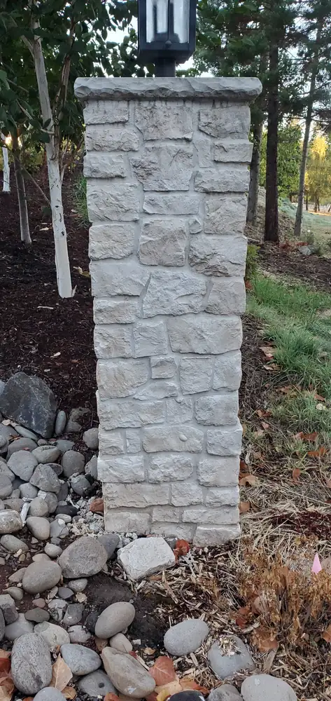 Stone veneer entry pillar and walkway with river rock Oregon