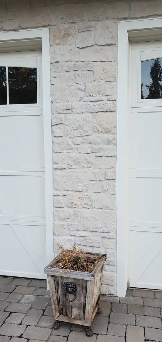 White stacked stone veneer exterior garage wall Oregon home