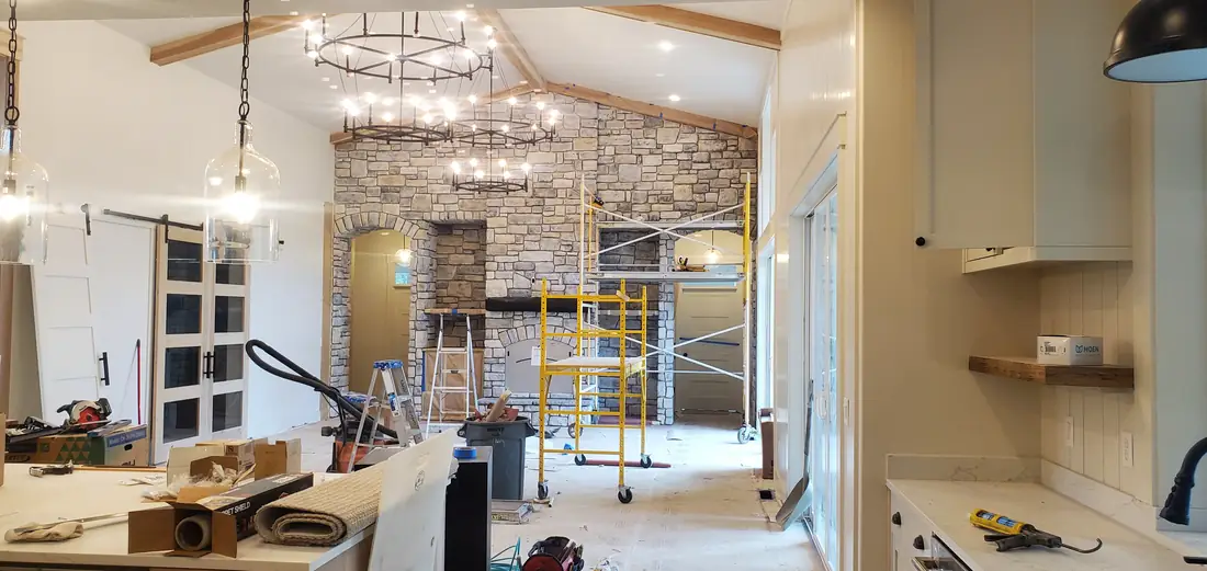 Great room stone veneer fireplace with vaulted ceiling under construction Oregon