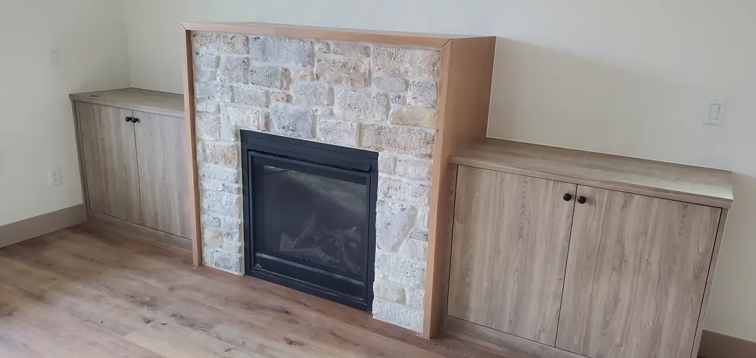 White stone veneer fireplace with built-in cabinets Oregon home