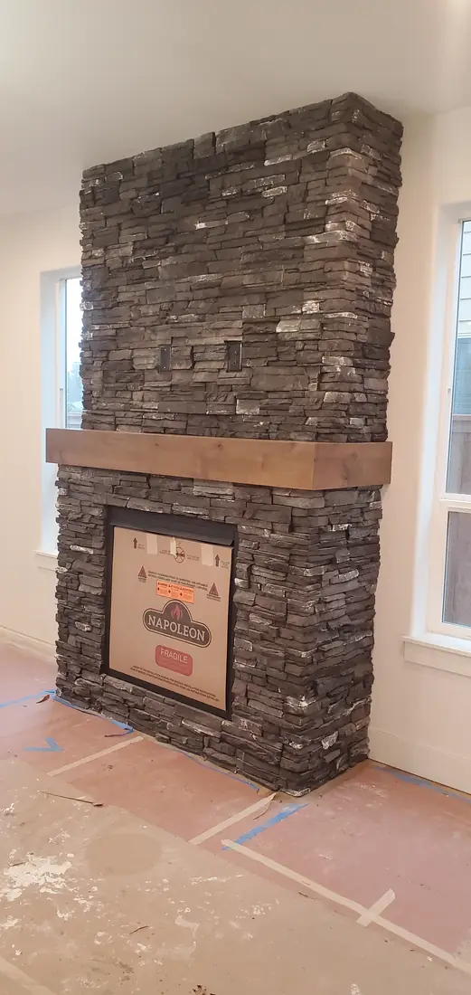 Dark stacked stone veneer fireplace surround installation Oregon