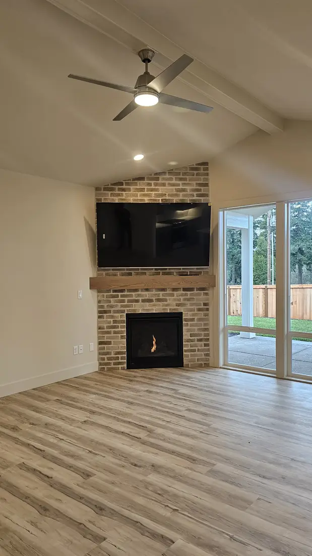White stone veneer fireplace with wall sconce and firebox Oregon