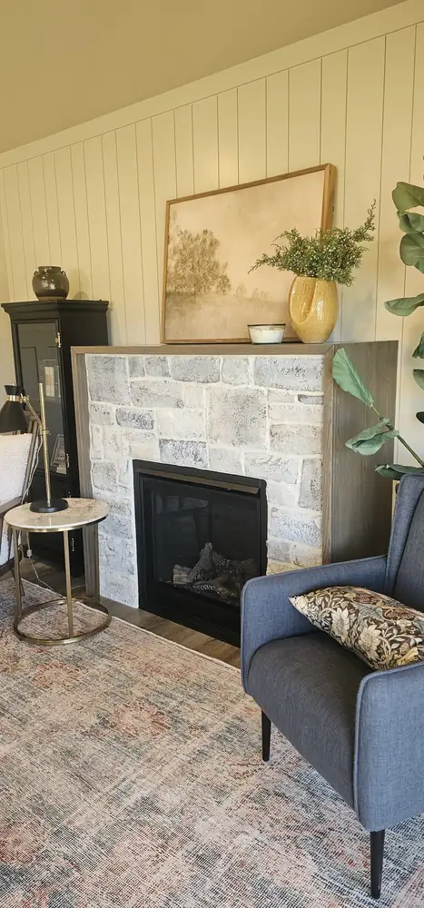 Staged living room with white stacked stone veneer fireplace Oregon